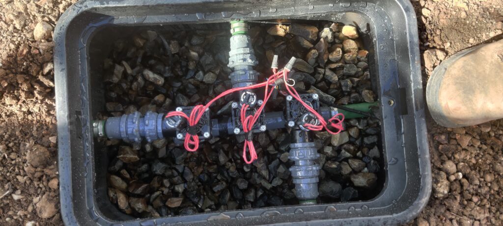 Top down view of a sprinkler valve box